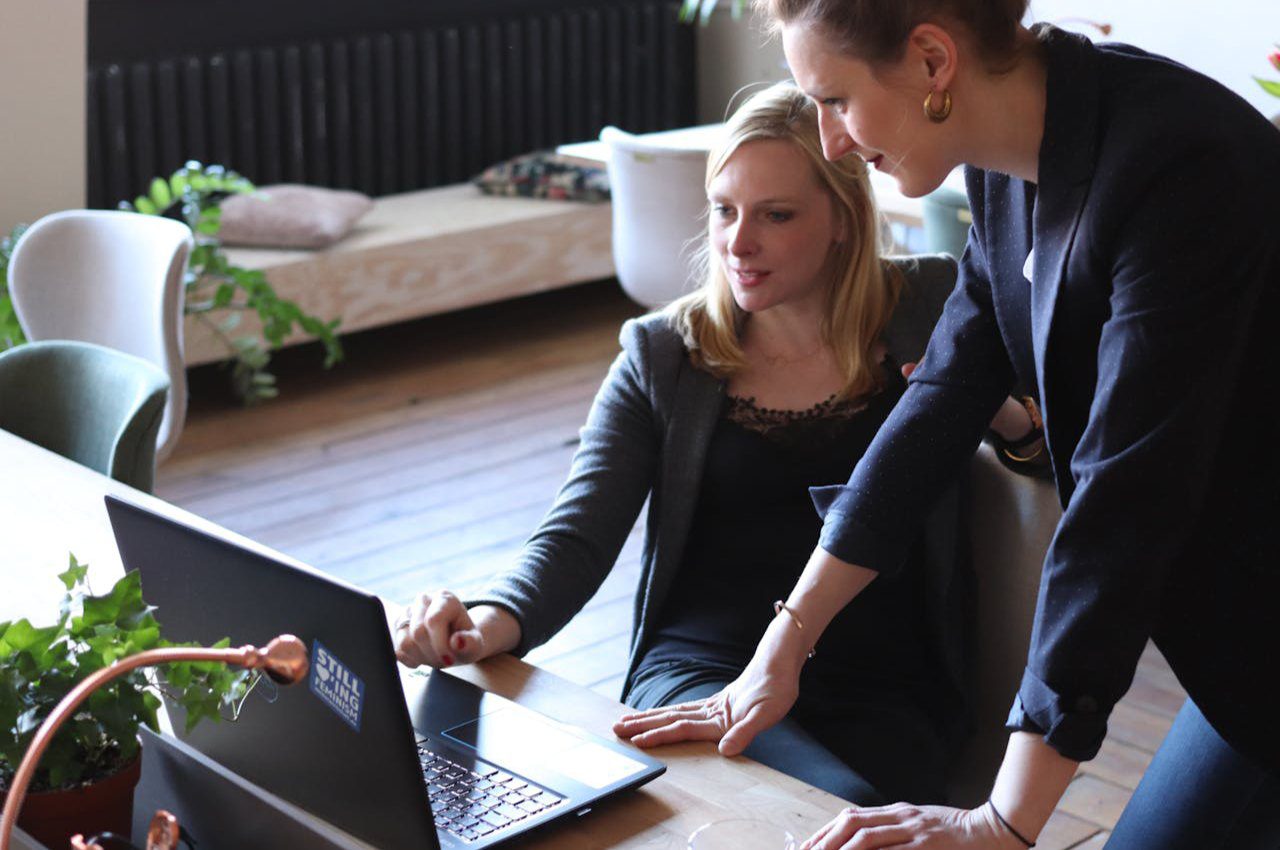 Two Women Using on Black Laptop Computer