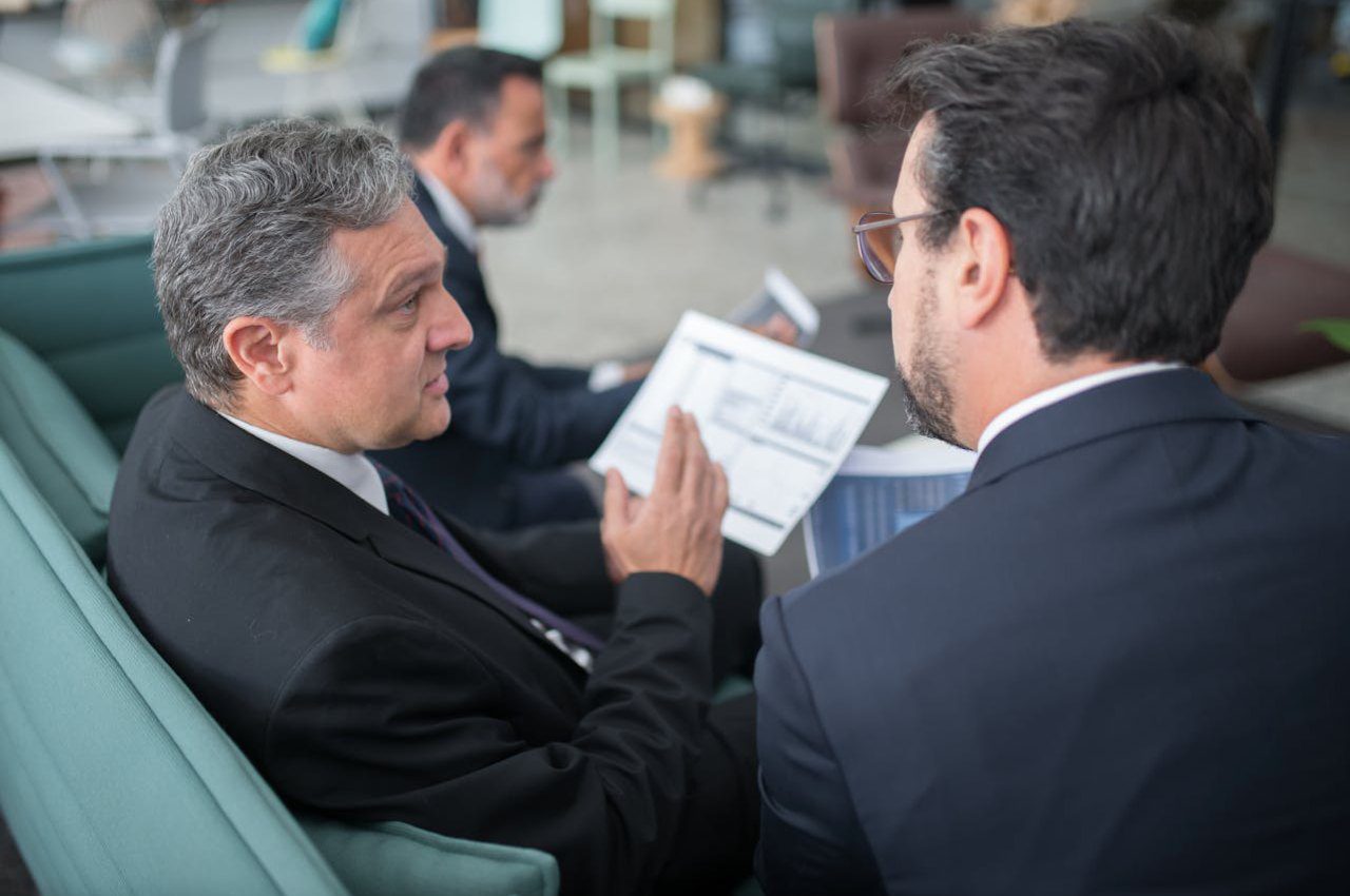 Men Sitting on Sofa Having a Discussion